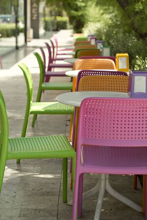 Plastic colorful tables and chairs in the cafe. The concept of foodの写真素材