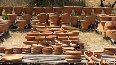 Huge clay jugs in the sun . Clay products trade