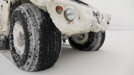 All-terrain vehicle for movement in hard-to-reach places. Car on the snow crust of the lake.の写真素材