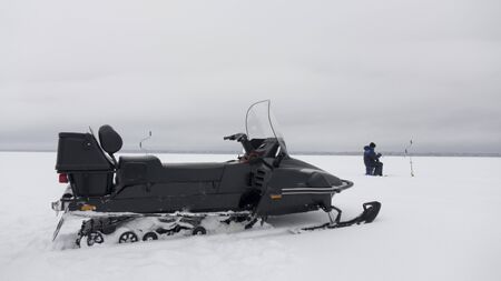 The snowmobile is intended for movement in hard-to-reach places on a snow crust of the lake.の写真素材