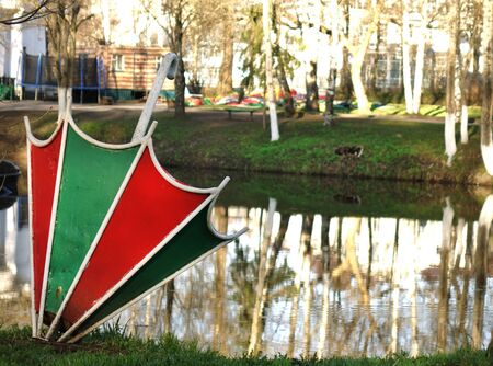 The metal umbrella is used as a flower bed in the city Park . Decoration of flower beds with various plants and umbrellasの写真素材