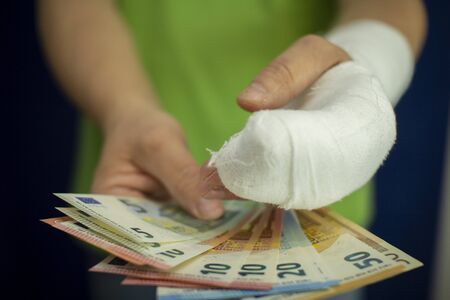 A man with an arm in a cast keeps money from the cost and expense of emergency medical care in a...