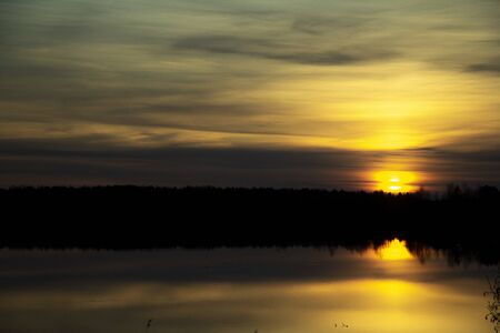 Beautiful sunset reflected in the lakeの写真素材