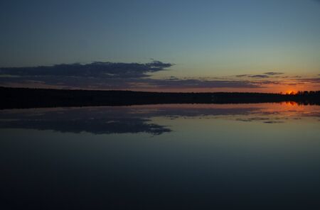 Beautiful sunset reflected in the lakeの写真素材