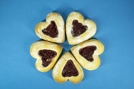 Sugar cookies in the shape of hearts for Valentine's Day. Blue background.の写真素材