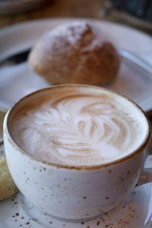 Ready-to-drink cappuccino with foam in a white Cup.の写真素材