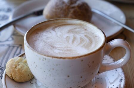 Ready-to-drink cappuccino with foam in a white Cup.の写真素材