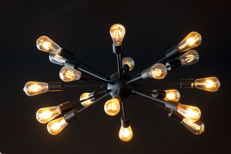 Lots of light bulbs on a dark background.の写真素材