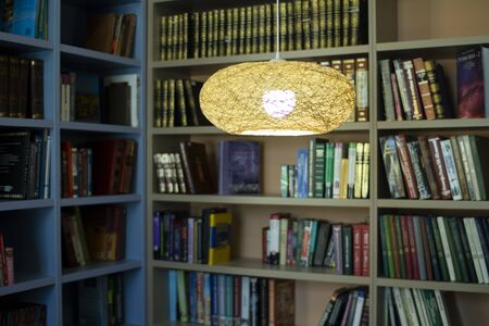 Lamp in the library . Bookshelves in the background.の写真素材