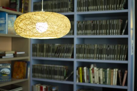 Lamp in the library . Bookshelves in the background.の写真素材