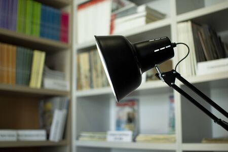 Lamp in the library . Bookshelves in the backgroundの写真素材