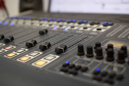 Professional audio mixing console with faders and adjustment knobs. Radio and television...