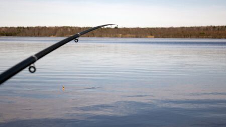 Fishing with a float rod on the waterの写真素材
