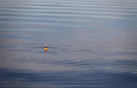 Fishing float on the water. Fishing with a float rod on the water.の写真素材