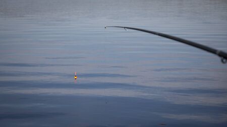 Fishing with a float rod on the waterの写真素材