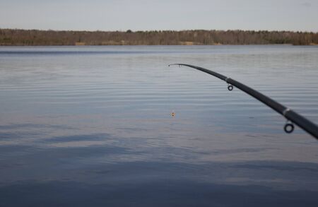 Fishing with a float rod on the waterの写真素材