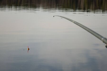 Fishing with a float rod on the waterの写真素材