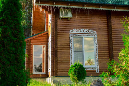 Wooden cottage in a pine forest.の写真素材