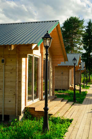 Wooden houses located on the lake shore are used for outdoor picnics with family or friends.の写真素材