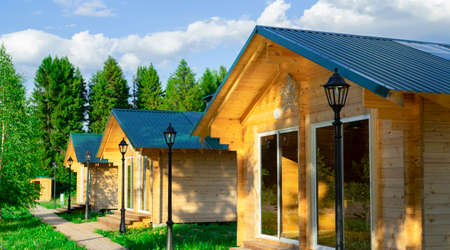 Wooden houses located on the lake shore are used for outdoor picnics with family or friends.の写真素材