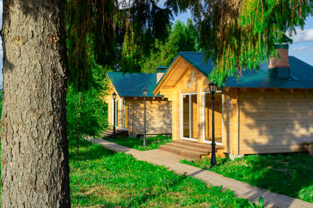 Wooden houses located on the lake shore are used for outdoor picnics with family or friends.の写真素材