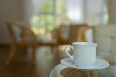 White Cup and rattan furniture on the summer porch.の写真素材