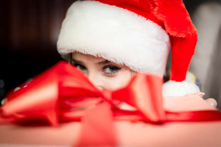 Beautiful blonde in a new years image with a gift box in her hands.の写真素材