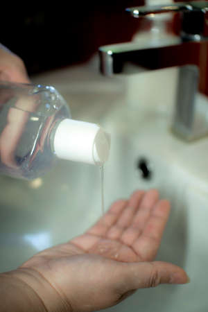 Woman washing her hand with liquid soapの写真素材