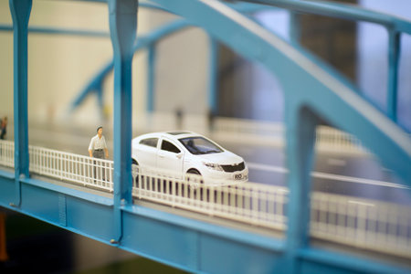 Miniature toy cars and people on the bridgeのeditorial素材