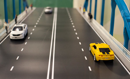 Miniature toy cars and people on the bridgeのeditorial素材