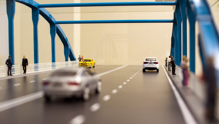 Miniature toy cars and people on the bridgeのeditorial素材
