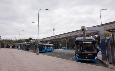 Moscow. Russia-August 2020: Blue electric bus at the charging station, charging from the pantograph.のeditorial素材