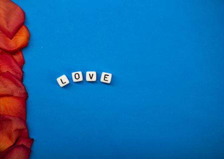 The word love on the background of rose petals . Valentines Day. Background concept of love and beautyの写真素材
