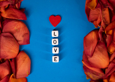 The word love on the background of rose petals . Valentines Day. Background concept of love and beautyの写真素材
