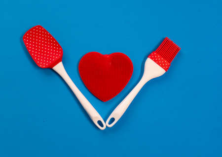 Silicone kitchen utensils with a red heart and a place for text. Kitchen banner for Valentines Day.の写真素材