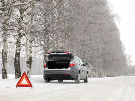 Emergency red sign on a snow-covered road.Car breakdown on the highway.の写真素材