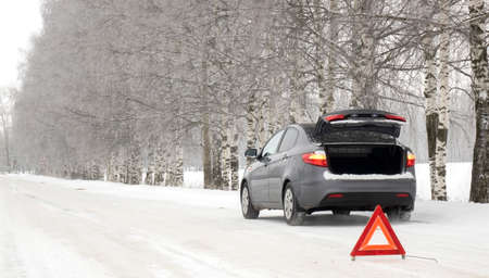 Emergency red sign on a snow-covered road.Car breakdown on the highway.の写真素材