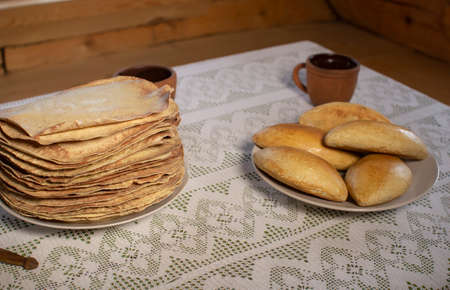 Pancakes in a wooden house on the background of a window.の写真素材