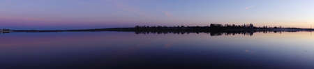 Panorama of the wide river on a summer evening.の写真素材