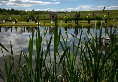 Fishing competitions among children. Fishermans Day at a fishing farm on July 14, 2020 in Ustye, Russia.のeditorial素材