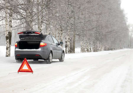 Emergency red sign on a snow-covered road.Car breakdown on the highway.の写真素材