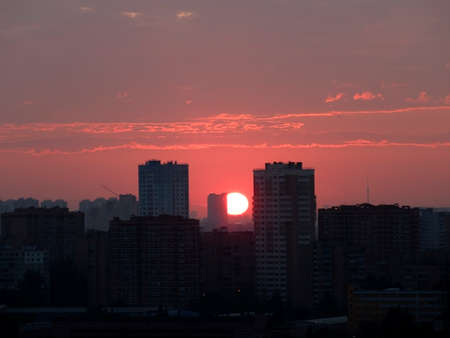 Sunrise over the city. The sun rises above the horizonの写真素材