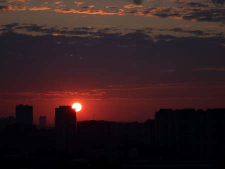 Sunrise over the city. The sun rises above the horizonの写真素材