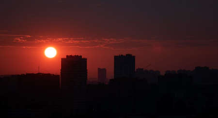 Sunrise over the city. The sun rises above the horizonの写真素材