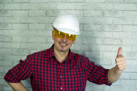 Portrait of a cheerful man in a construction helmet .の写真素材