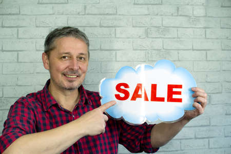 The man offers a sale. The season of New Year salesの写真素材