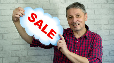The man offers a sale. The season of New Year salesの写真素材