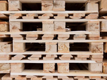 The pallets are located in a stack in the warehouse.