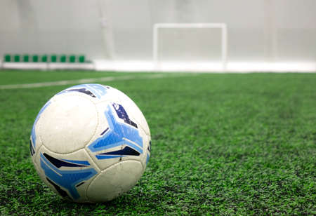 A soccer ball placed on a green grass lawn with a copy space.の写真素材