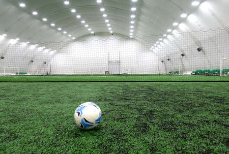 A soccer ball placed on a green grass lawn with a copy space.の写真素材